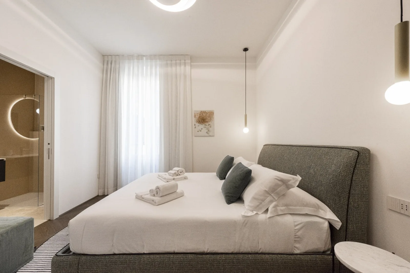 The third bedroom, serene in cream and travertine